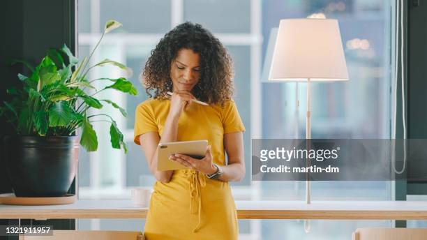 businesswoman in coworking space - yellow dress stock pictures, royalty-free photos & images