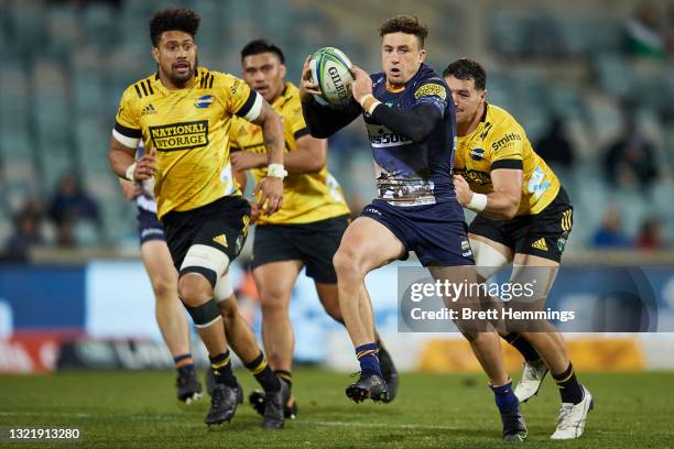 Tom Banks of the Brumbies makes a break during the round four Super Rugby Trans-Tasman match between the ACT Brumbies and the Hurricanes at GIO...