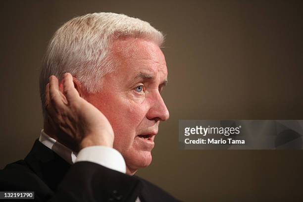 Pennsylvania Governor Tom Corbett listens to a question at a news conference following a night of rioting in response to the firing of head football...