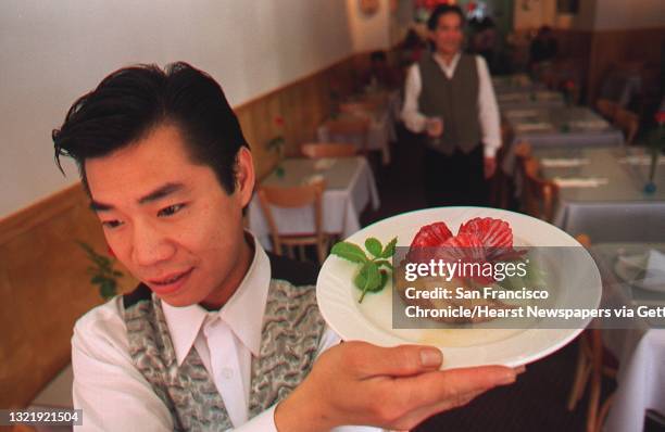 Simple, open Vietnamese restaurant "LA VIE" in San Francisco. Waiter Minh Tang carries a Fresh Fruit Tart dessert. Chronicle Photo: Michael Macor