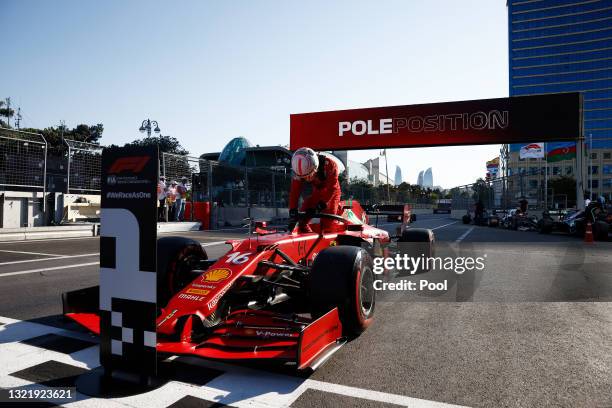 Pole position qualifier Charles Leclerc of Monaco and Ferrari celebrates in parc ferme during qualifying ahead of the F1 Grand Prix of Azerbaijan at...