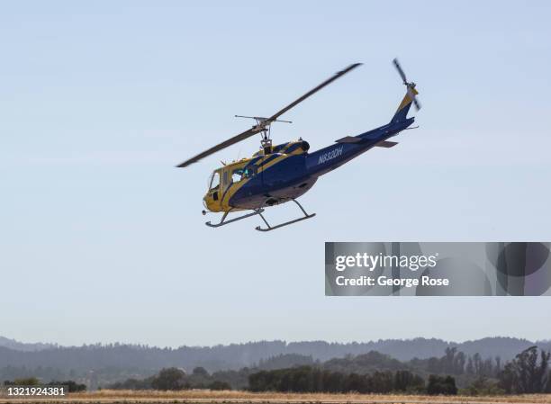 Water dropping Huey helicopter, contracted by Cal Fire, is viewed taking off at Charles M. Schulz Sonoma County Airport in this aerial photo taken on...