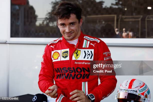 Pole position qualifier Charles Leclerc of Monaco and Ferrari celebrates in parc ferme during qualifying ahead of the F1 Grand Prix of Azerbaijan at...