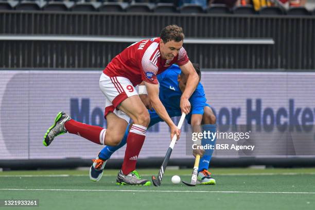 Harry Martin of England, Semen Matkovskiy of Russia battle for possession during the Euro Hockey Championships match between England and Russia at...