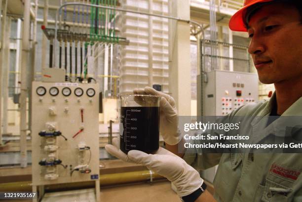 Production plant, Folsom Ca. Soy Sauce production, brewing manager, Munenori Nakano with a test sample of Soy Sauce before full scale production...