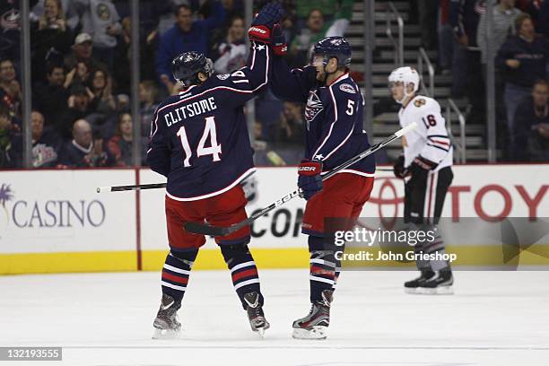 Grant Clitsome and Aaron Johnson of the Columbus Blue Jackets celebrate a first period goal during their game against the Chicago Blackhawks at...