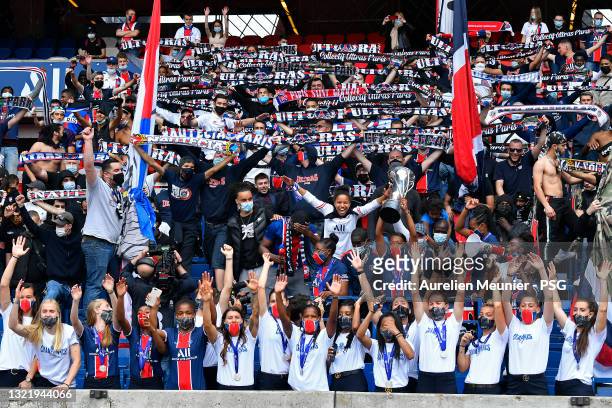 Paris Saint-Germain Women players hold the trophy in front of their fans during the Celebration of the title of French champion D1 Arkema at Parc des...
