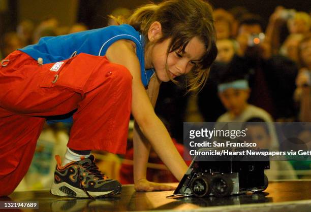 Year old Alodie Mourier of Sebastopol finds out just how strong the robots are as she tries to hold one back by pushing against it. 3rd Annual...