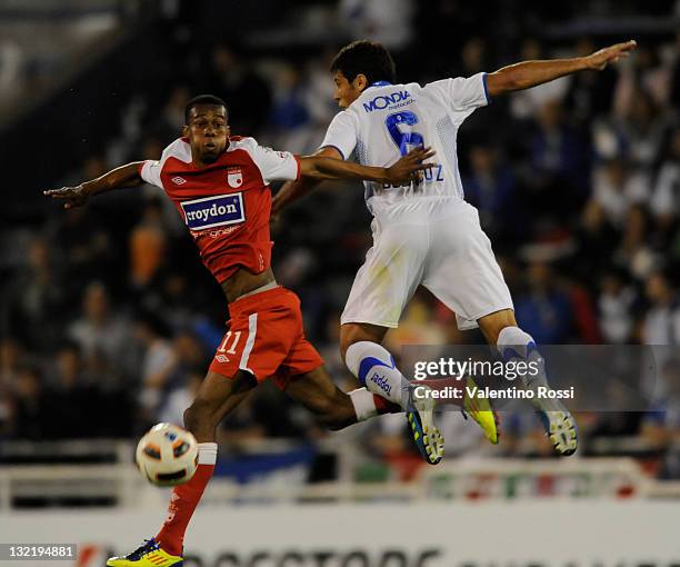 Sebastian Dominguez of Velez Sarsfield from Argentina fights for the ball with Jonathan Copete of Independiente Santa Fe from Colombia during a match...