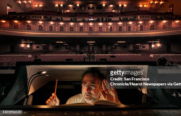 Jonathan Khuner is his prompter position, downstage with his back to the audience, Khuner sits in the small box singing along with the entire opera,...