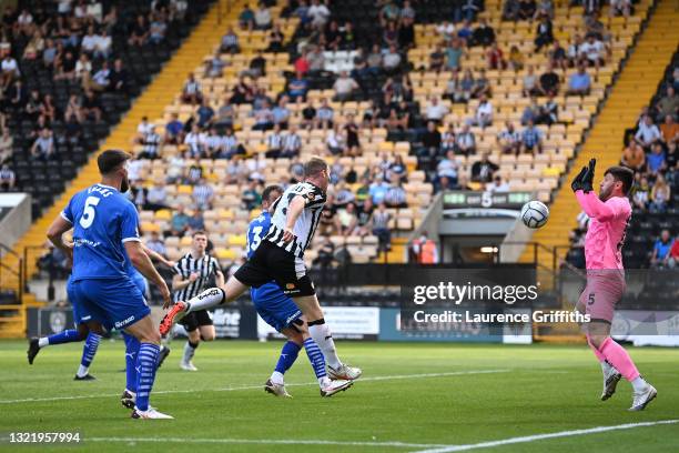 Mark Ellis of Notts County scores their team's third goal past James Montgomery of Chesterfield during the Vanarama National League Play Off match...