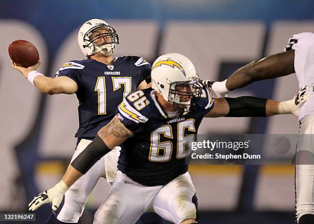 Quarterback Philip Rivers of the San Diego Chargers throws the ball in the first half as Jeromey Clary blocks as they take on the Oakland Raiders at...