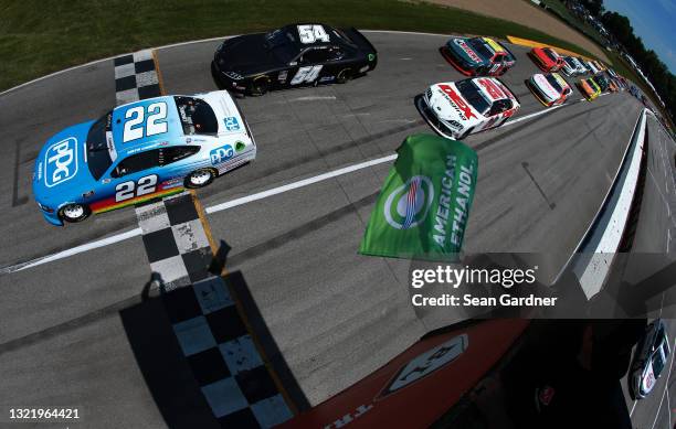 Austin Cindric, driver of the PPG Ford, leads Ty Gibbs, driver of the Joe Gibbs Racing Toyota, and Harrison Burton, driver of the DEX Imaging Toyota,...