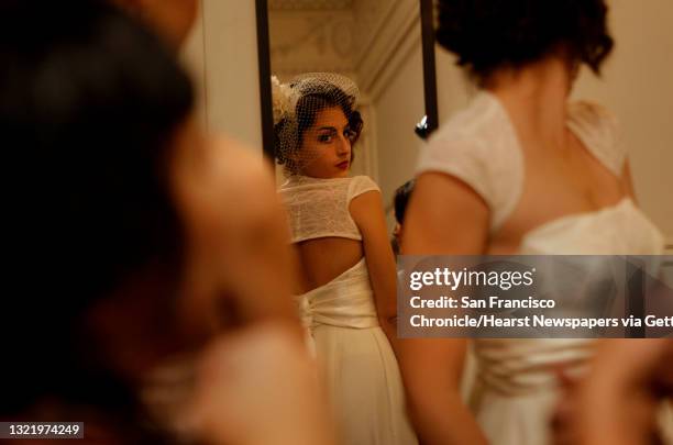 Model Reny Preussker does a last minute check of her wedding gown by designers Nicole Kreglow and Stephanie Bodnar, their collection, "OdileOdette"...