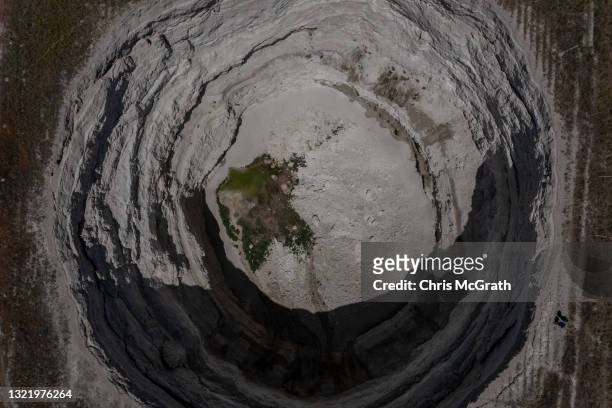 In an aerial view, a massive sinkhole is seen in the middle of a field on June 03 in Karapinar, Turkey. In Turkey’s Konya province, the heart of the...