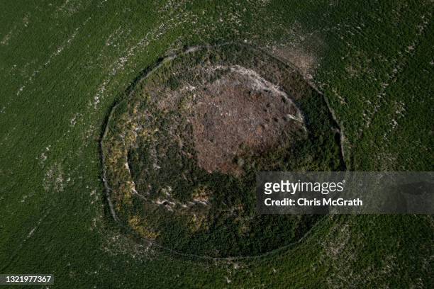 In an aerial view, a large sinkhole is seen in a field on June 03 in Karapinar, Turkey. In Turkey’s Konya province, the heart of the country's...