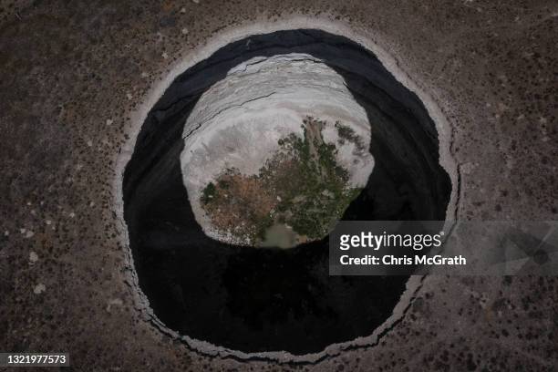 In an aerial view, a massive sinkhole is seen on the outskirts of a village on June 03 in Karapinar, Turkey. In Turkey’s Konya province, the heart of...