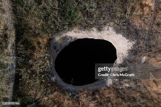 In an aerial view, a large sinkhole is seen in a field on June 03 in Karapinar, Turkey. In Turkey’s Konya province, the heart of the country's...