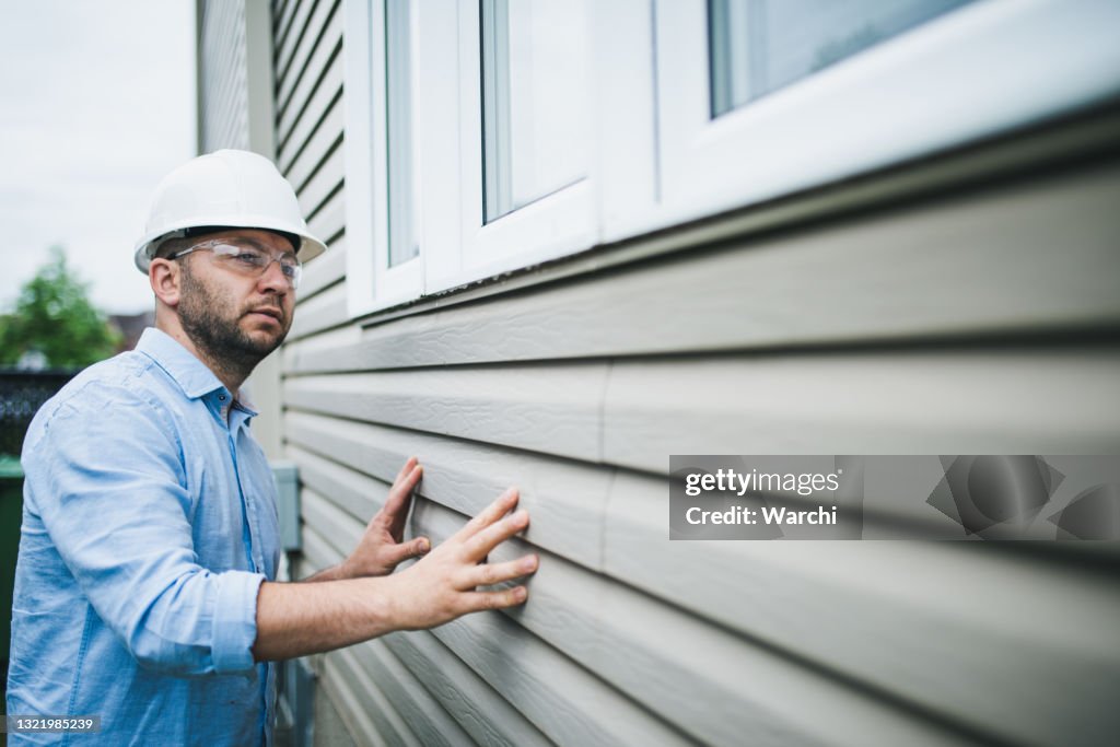 Building inspector checking the windows of a residential building
