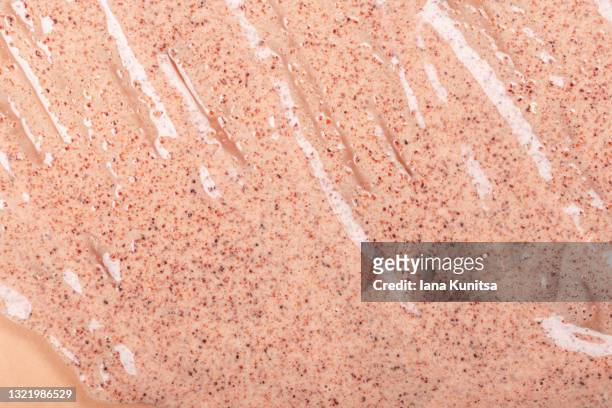 skin care. coffee anti-cellulite body scrub is smeared on beige background. exfoliation. - scrubbing stock pictures, royalty-free photos & images