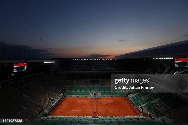 General view of the sunset over Court Philippe-Chatrier as Dominik Koepfer of Germany serves during his Men's Singles third round match against Roger...