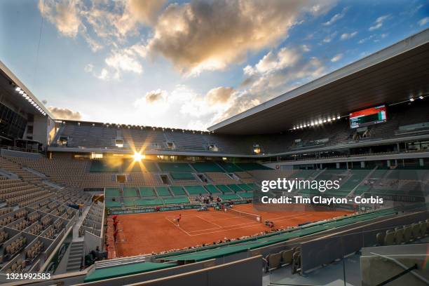 June 5. The sun goes down over Paris as Roger Federer of Switzerland and Dominik Koepfer of Germany compete in the evening match in the empty stadium...