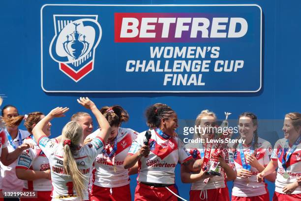 Chantelle Crowl of St Helens celebrates with the Betfred Women's Challenge Cup trophy as her team mates celebrate after the Betfred Women's Super...