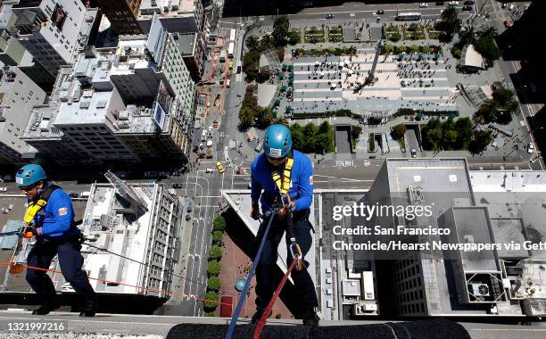 Hector Baiza, of Walnut Creek and Elon Steers, of Vallejo, join dozens of participants as they rappel from the top of the Grand Hyatt Hotel in...