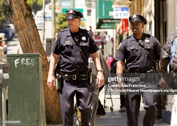 San Francisco police officers, Sgt. Ian Furminger, and Dennis Toomer, work the Tenderloin district along Leavenworth St., on Wednesday May 30 in San...