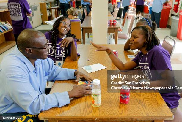 Jeffery, and his wife Claudia, talks things over with his daughters, Dorisha, 21 and Curia,16 during the 13th Annual ?Get on the Bus? event, at San...