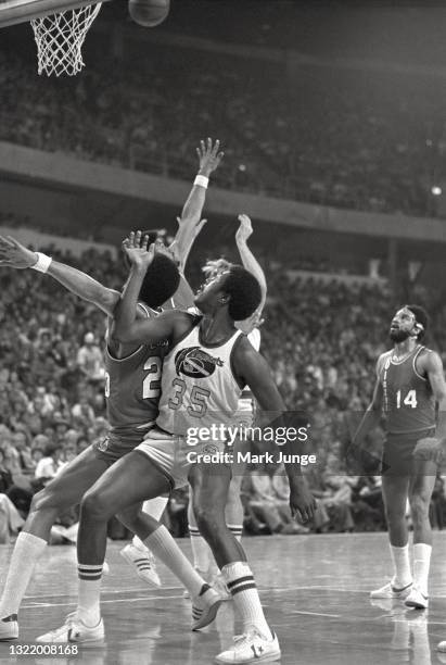 Denver Nuggets forward Paul Silas is blocked out from a rebound by Portland Trail Blazers forward Maurice Lucas during an NBA basketball game against...