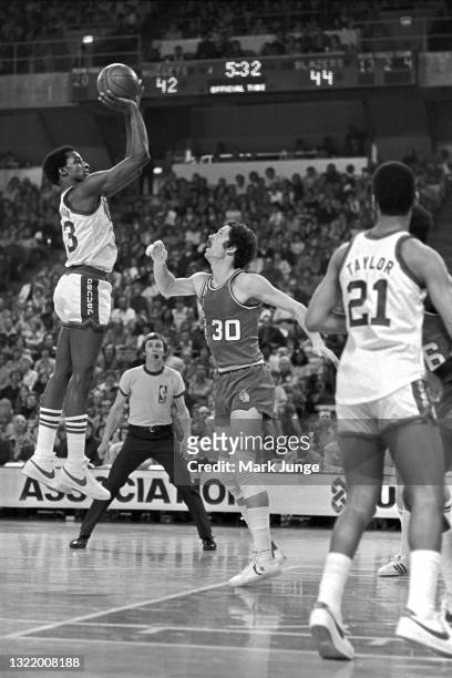 Denver Nuggets forward David Thompson goes up for a jump shot against Portland Trail Blazers forward Bob Gross during an NBA basketball game at...