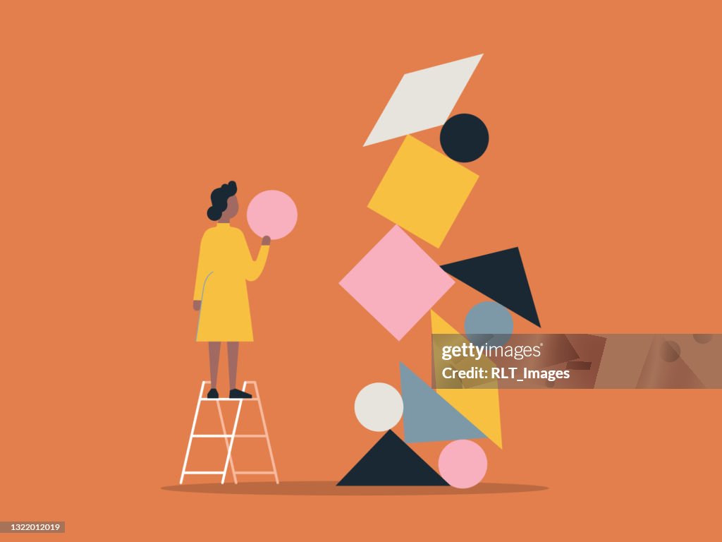 Illustration of person building with balanced shape blocks