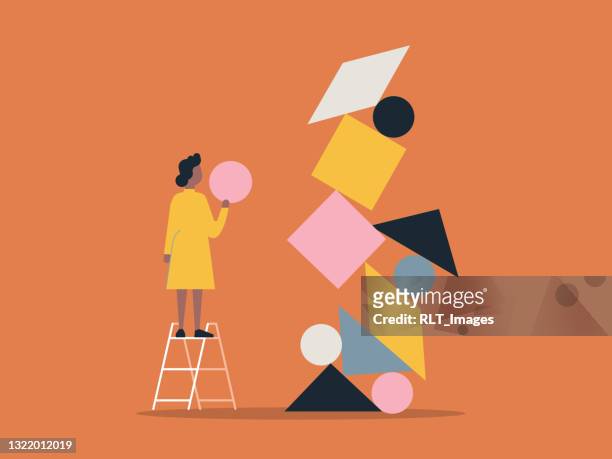 illustration of person building with balanced shape blocks - solutions stock illustrations