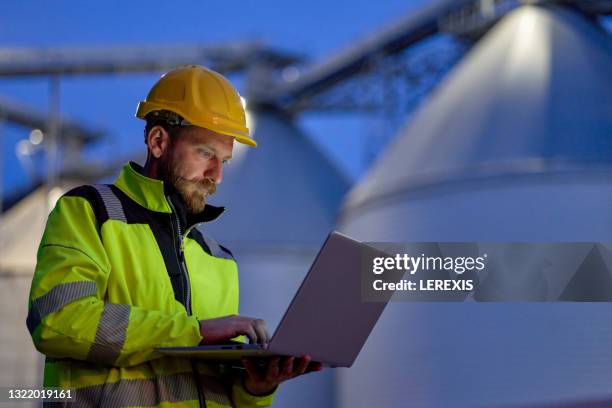 man in a factory with a computer - biofuel stock pictures, royalty-free photos & images