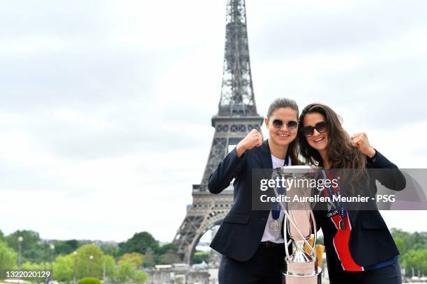 Signe Bruun and Sara Dabritz pose with the trophy next to the Eiffel Tower during the Celebration of the title of French champion D1 Arkema at Parc...