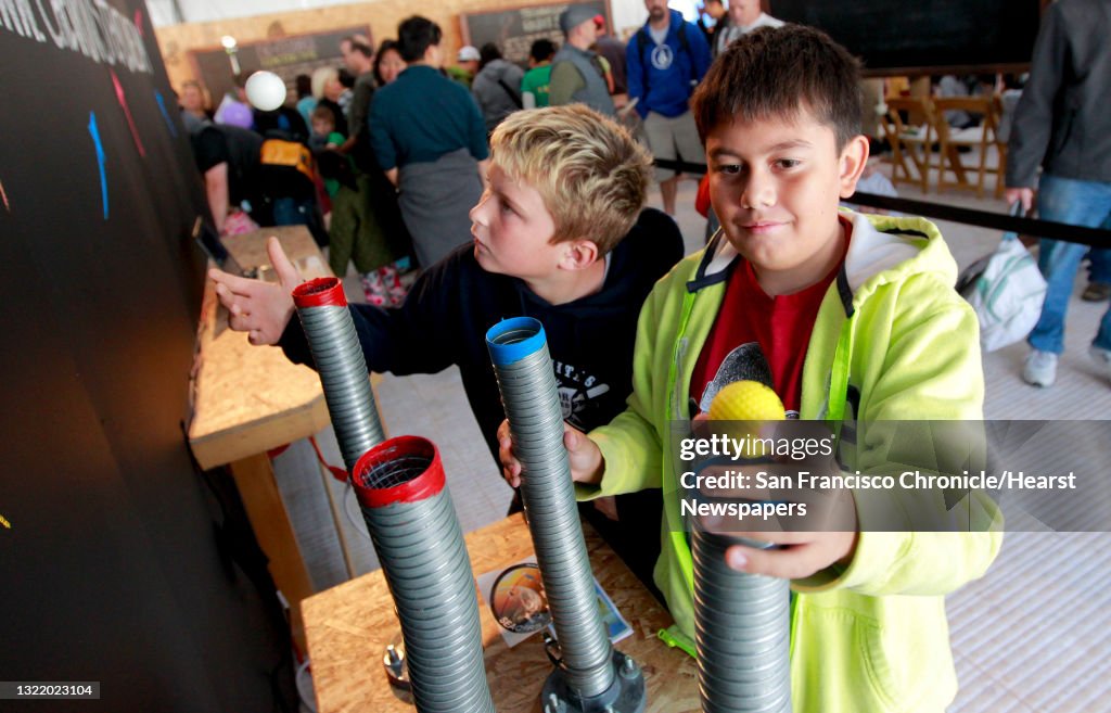 Aidan Sgarlato, 11 and Antonio Ross, 10 from San Jose learn the Bernoulli Principle and how air pressure between moving a still air keeps a ping pong ball suspended, during the Bay Area Science Festival at AT&T Park in downtown San Francisco, Calif. on Sa