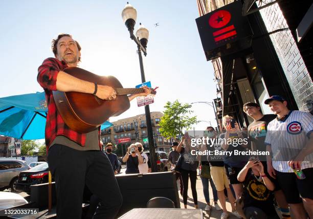 Singer Tim McIlrath of the punk rock band Rise Against performs outside of Reckless Records for fans who were unable to get in to see the in-store...