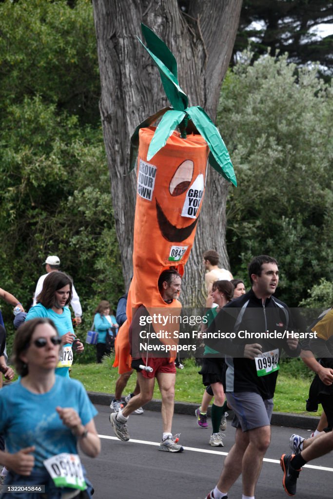 A runner in a carrot costume runs down John F. Kennedy Drive in Golden Gate Park during Bay to Breakers in San Francisco on Sunday.