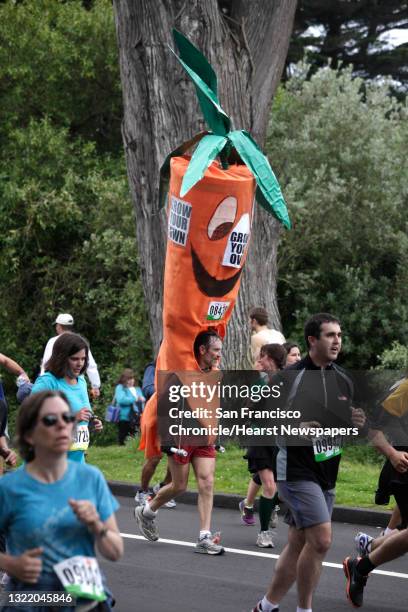 Runner in a carrot costume runs down John F. Kennedy Drive in Golden Gate Park during Bay to Breakers in San Francisco on Sunday.