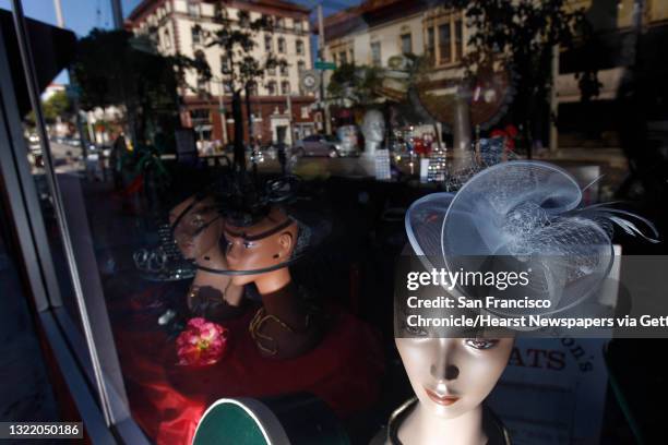 Hats are displayed in the window of Mrs. Dewson's Hats on Fillmore street where the surrounding neighborhood is reflected in the windows in San...