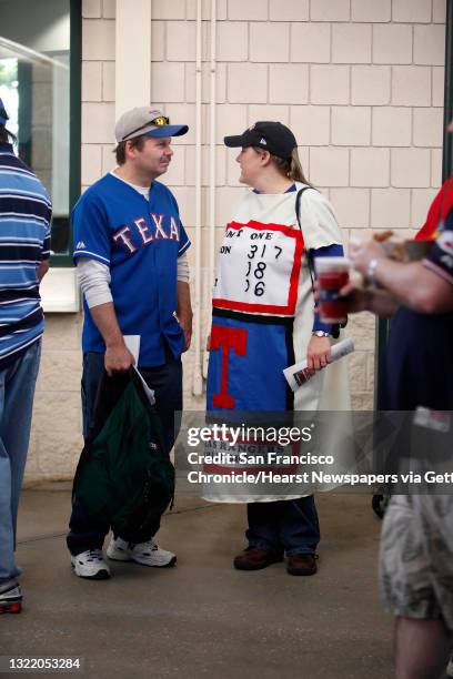 Kelly Martin of Fort Worth, Texas, talks to her husband, Steve Martin, before Game 4 of the World Series at Rangers Ballpark on Sunday. Kelly Martin...