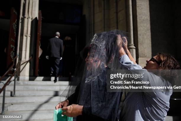 Paloma Volare St. James gets help adjusting her veil from Rochelle Franson before Volare St. James attends the funeral for Jose Julio Sarria at Grace...