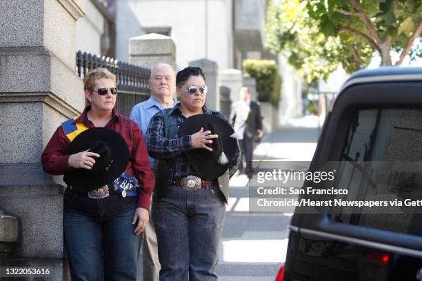 Judy James and D. Trujillo-James, both with the Golden State Gay Rodeo Association, pay their respects as the hearse carrying Jose Julio Sarria...