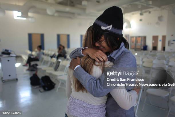 Hillsdale High School juniors Jessica Fitzgerald, 16 and Francis lewin-Koh hug after they both made separate phone calls and talked to Elizabeth...