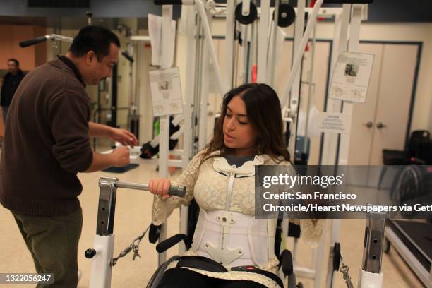 Katy Sharify, who received stem cell therapy before the study she was part of was cancelled, does bench presses in the Cypress Semiconductor Spinal...