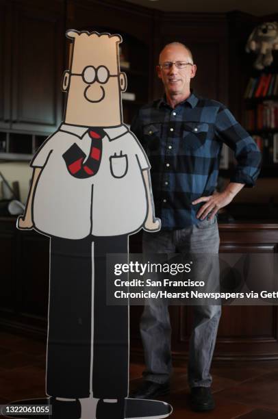 Scott Adams, cartoonist and author and creator of "Dilbert", poses for a portrait with a life-sized Dilbert cutout in his home office on Monday,...