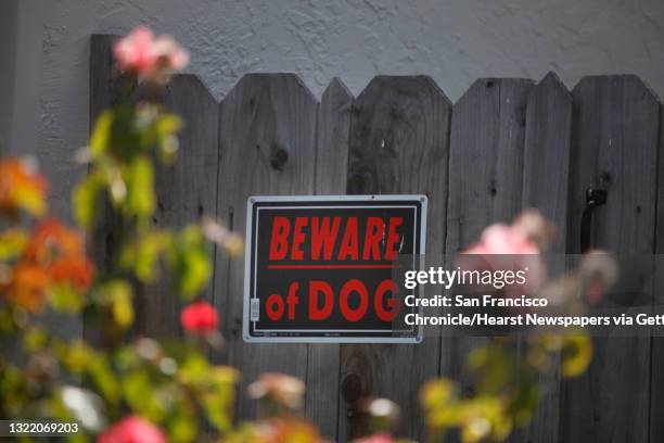 Sign on a fence at the home where a six-year-old boy was mauled on Monday by a relative's dog warns people to Beware of Dog on Tuesday, June 18, 2013...