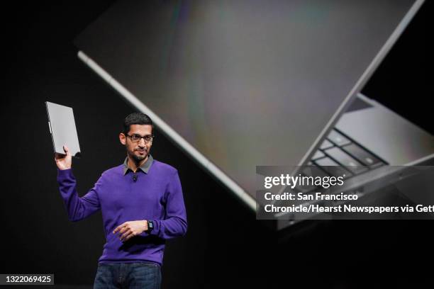 Sundar Pichai, senior vice president, Chrome and Apps at Google, holds a Chromebook Pixel laptop computer during the keynote presentation at Google...