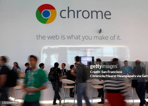 Google I/O conference attendees walk past a Google Chrome Office Hours booth at the Google I/O conference at Moscone West on Thursday, June 28, 2012...